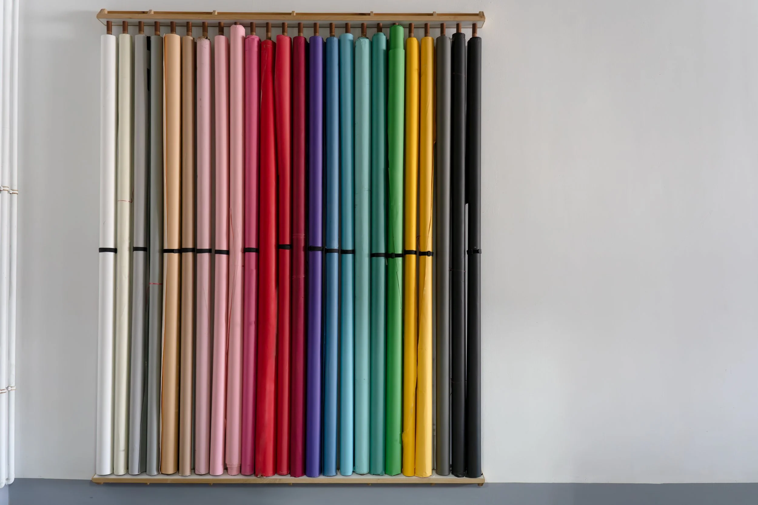 The backdrop rack — dozens of seamless paper rolls in every colour