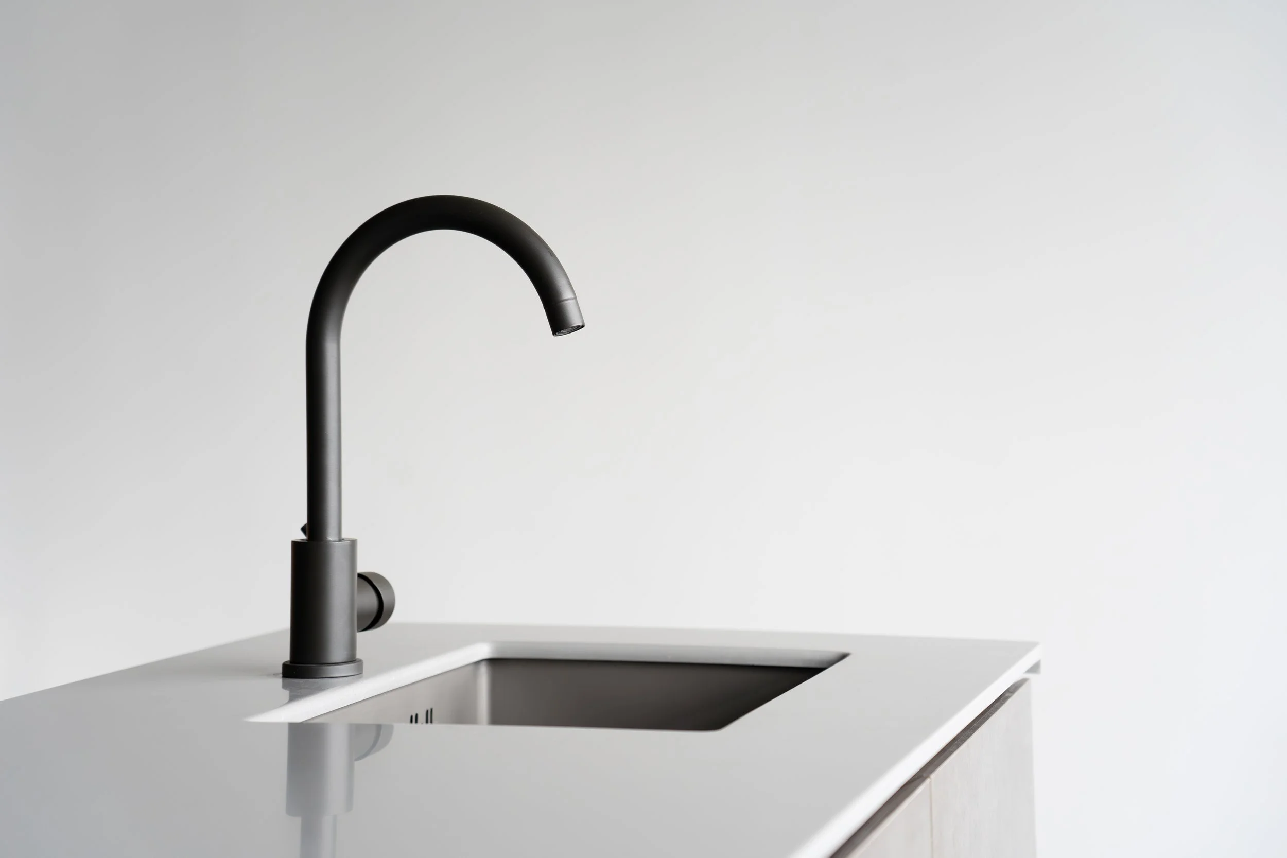 Matte black tap on the kitchen island